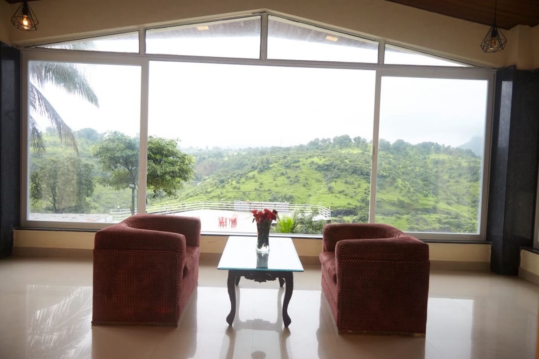 Lounge with a full glass wall facing the hills