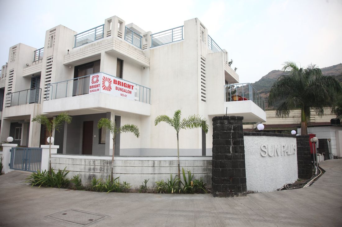Villa frontage with palms at Sun Palms